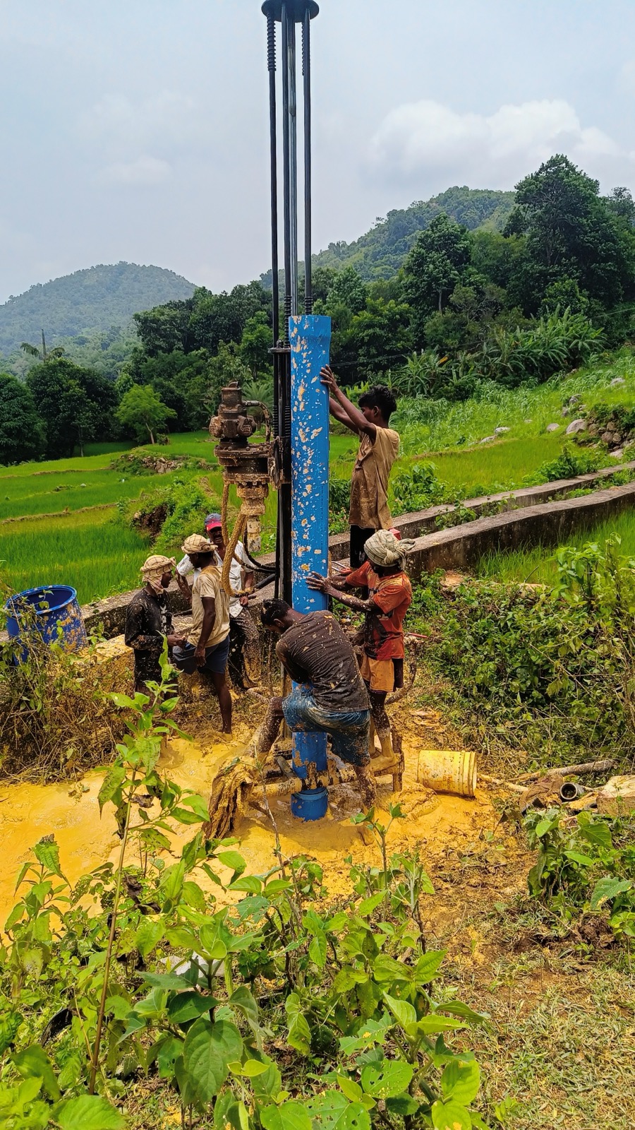 RR BOREWELLS crew working at a rural field drilling site